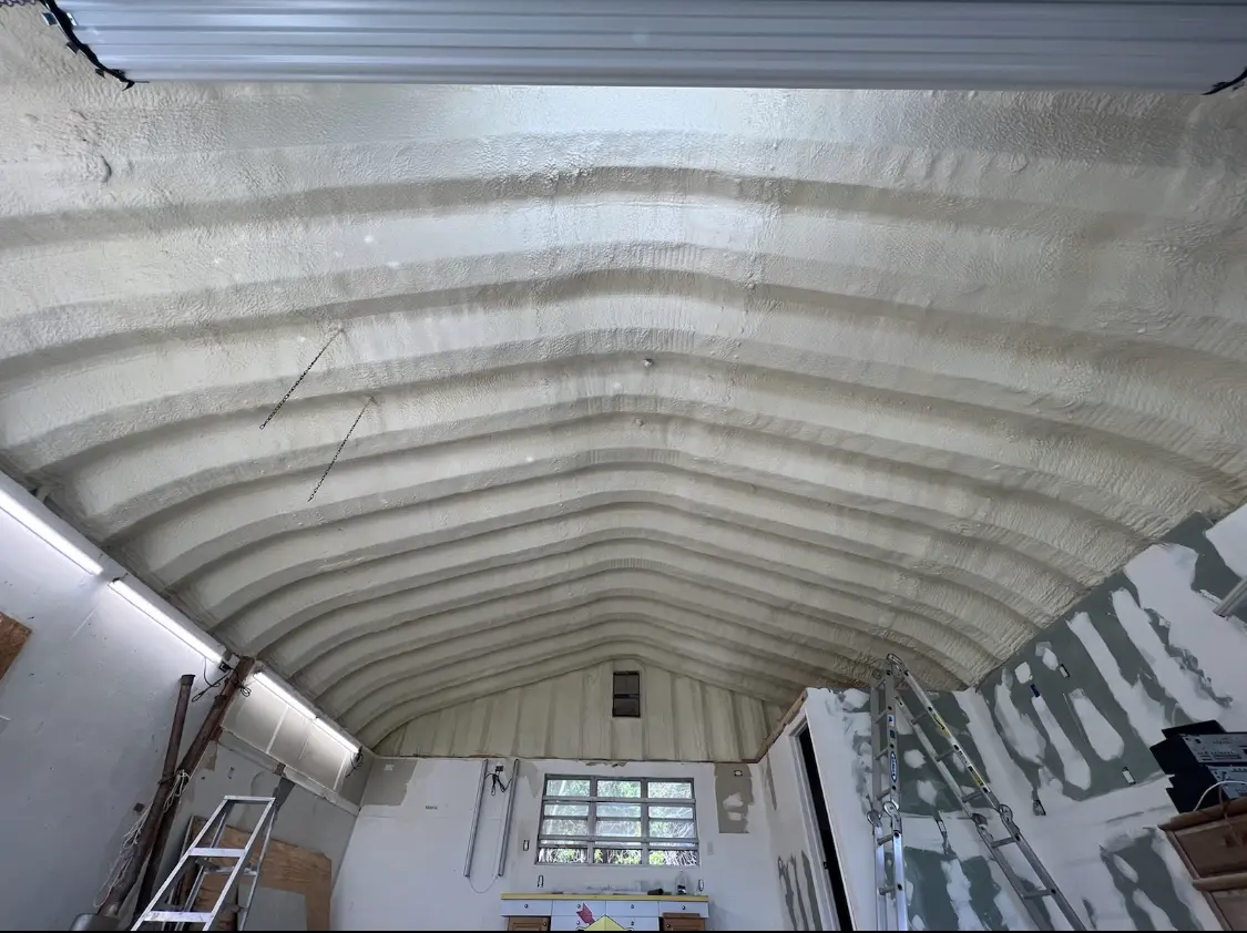 Spray polyurethane foam applied to the underside of a metal roof deck in Wake Forest